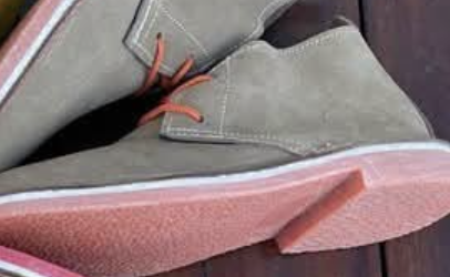 Suede vellies with vibrant coloured soles arranged in a circular display — Tan with Light Pink Sole