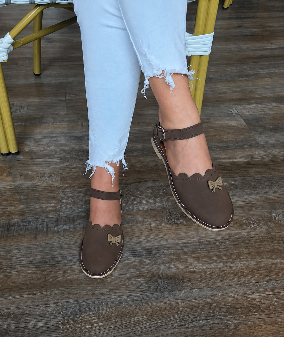 Soft chocolate vellies with bow detail, scalloped trim and ankle strap — Standing View